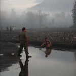 Captain Sumitro washes at the Kraras River