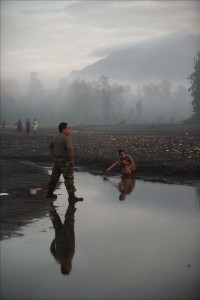 Captain Sumitro washes at the Kraras River